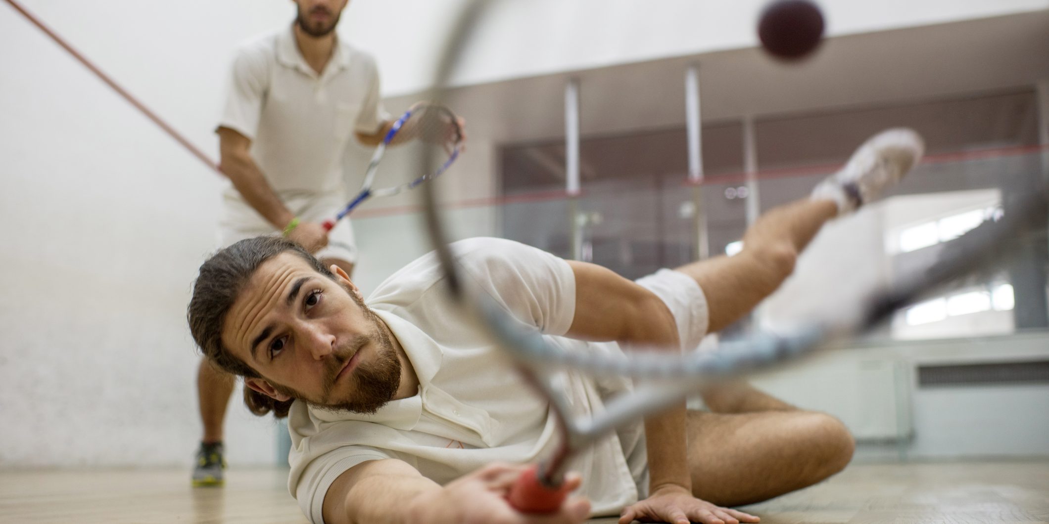 Reaching for the squash ball!